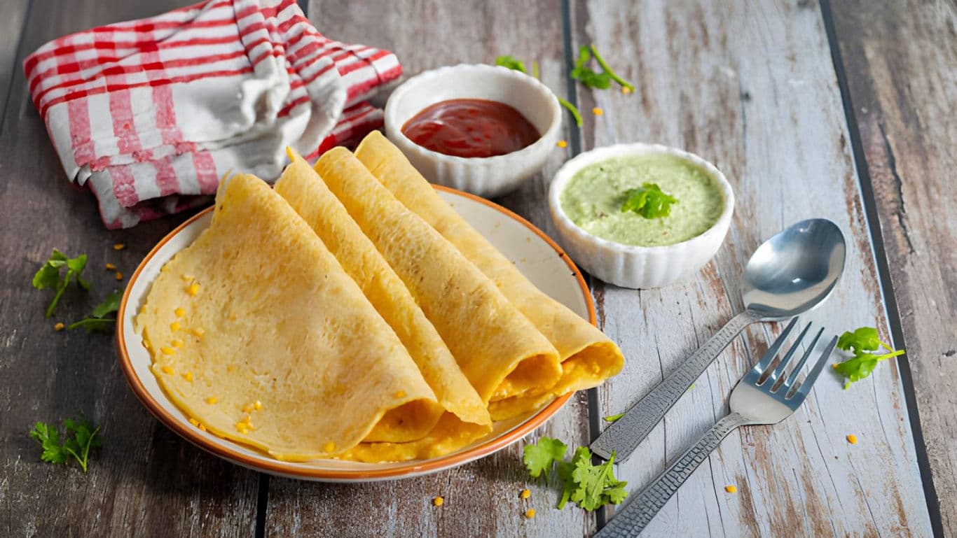 Savory crepes with chutneys on wooden table