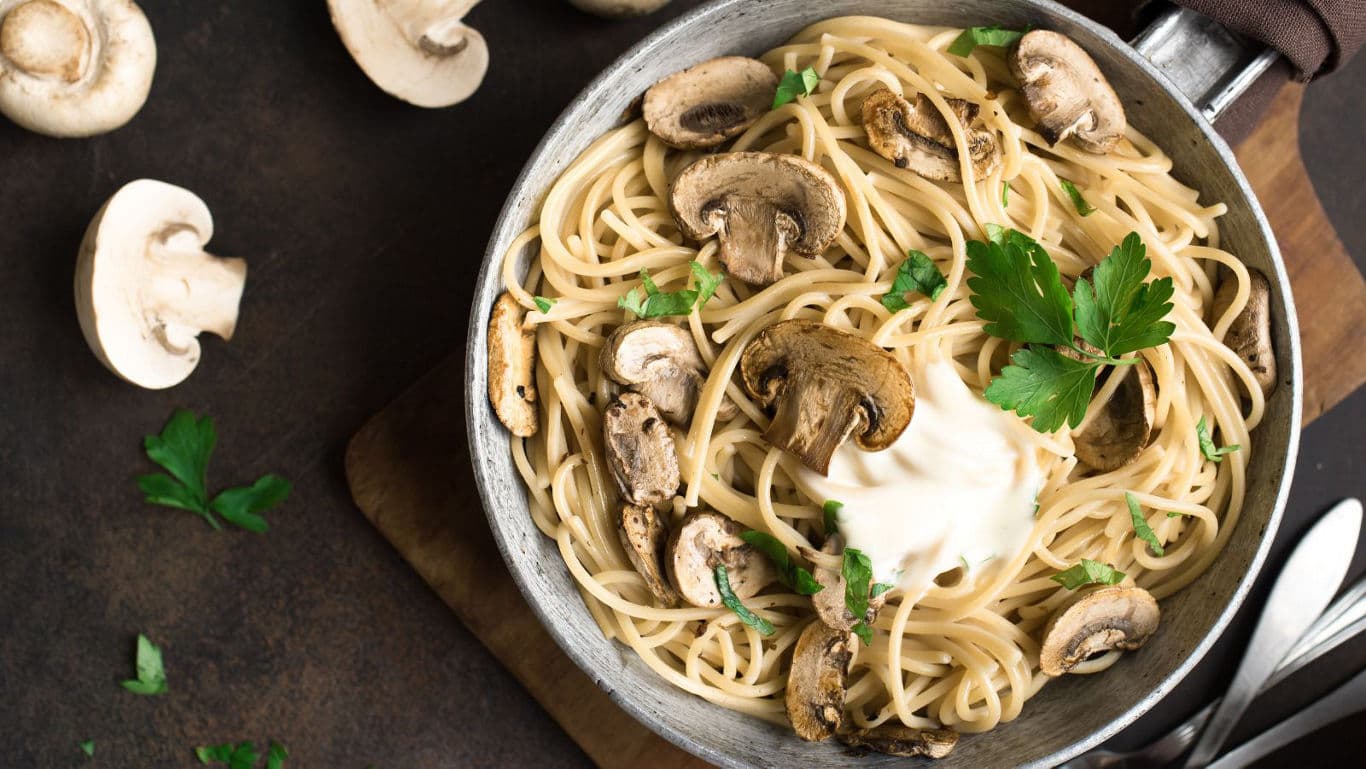 Creamy mushroom pasta in rustic setting