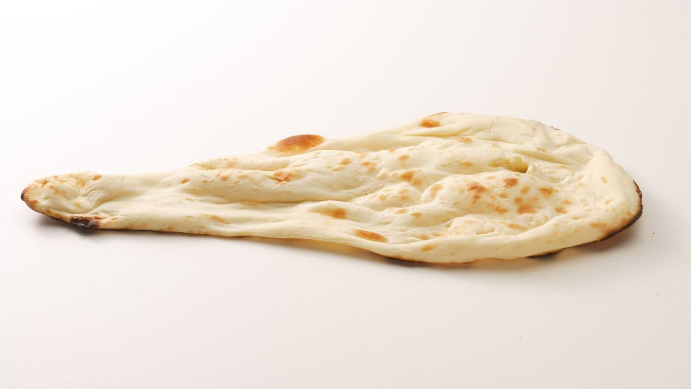 Freshly baked naan bread on white