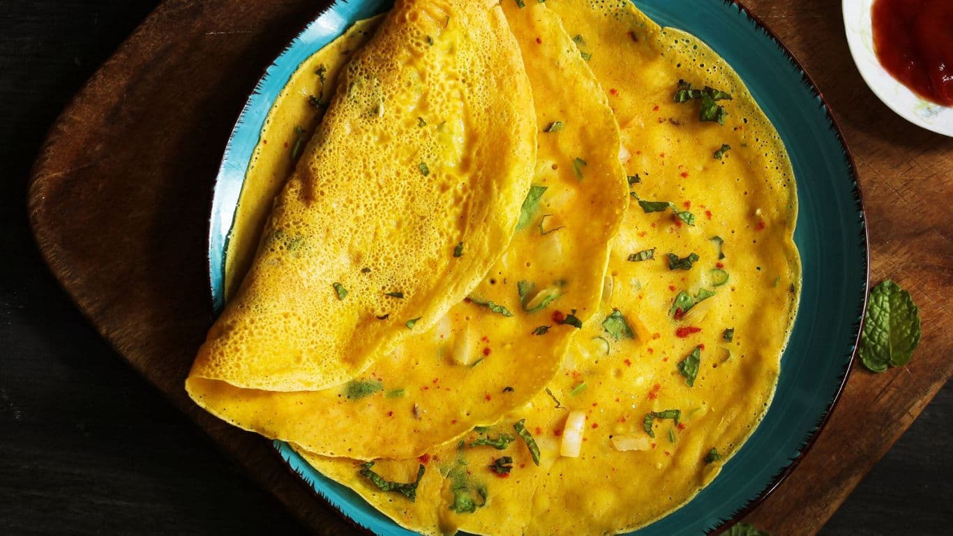 Savory yellow crepes on blue plate