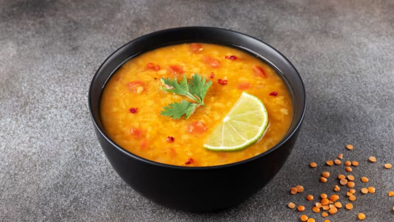 Bowl of Lentil Soup with Lime Garnish