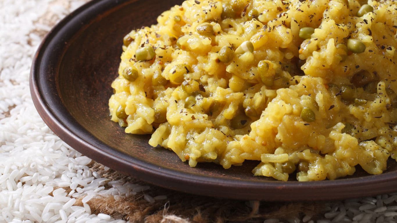 Yellow lentil rice dish on rustic plate