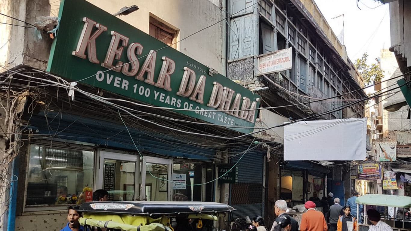Kesar Da Dhaba storefront in bustling street