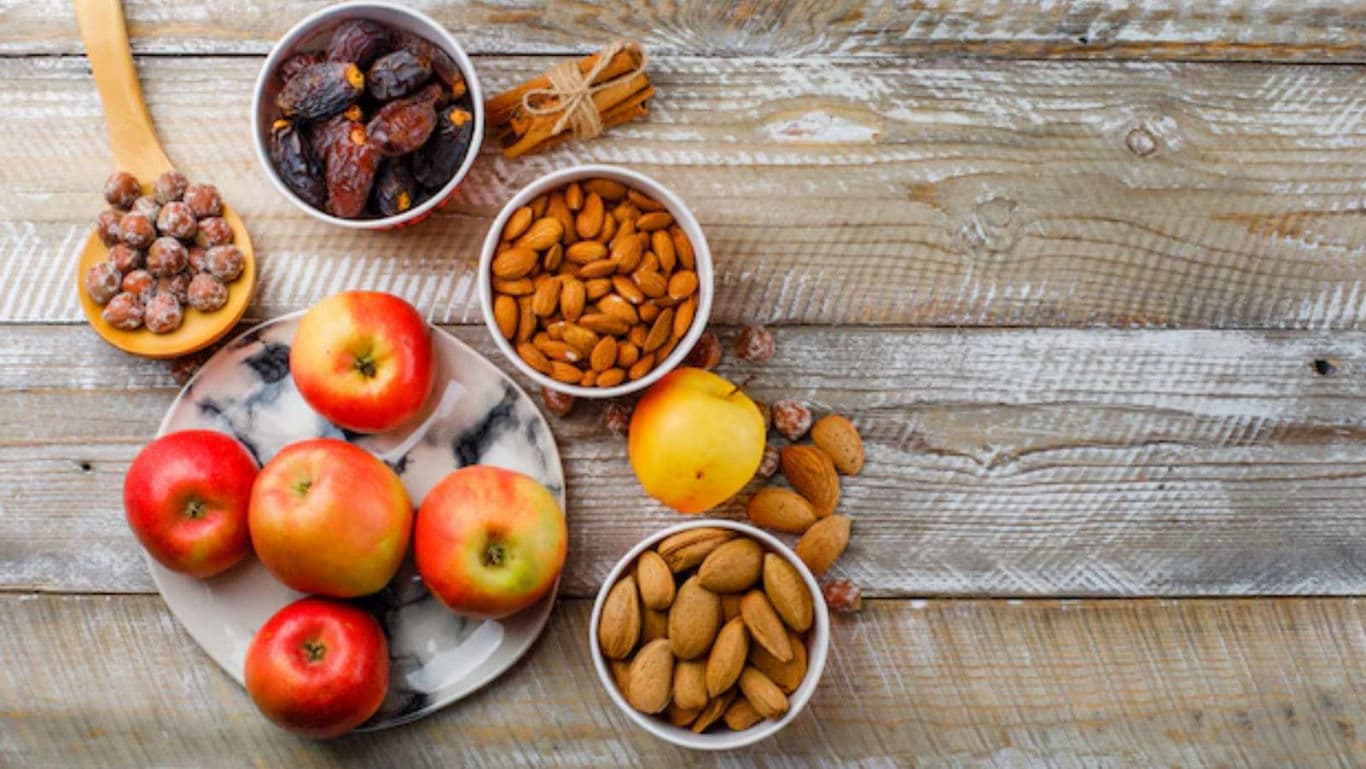 Fresh apples, nuts, and dried fruits on rustic table