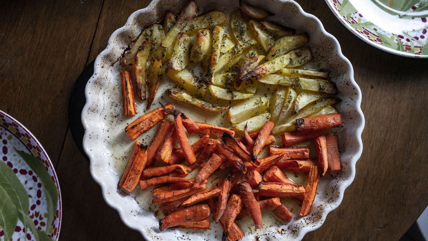 Roasted carrots and potatoes in ceramic dish