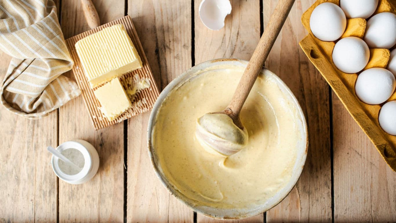 Baking Ingredients and Batter on Rustic Wooden Table
