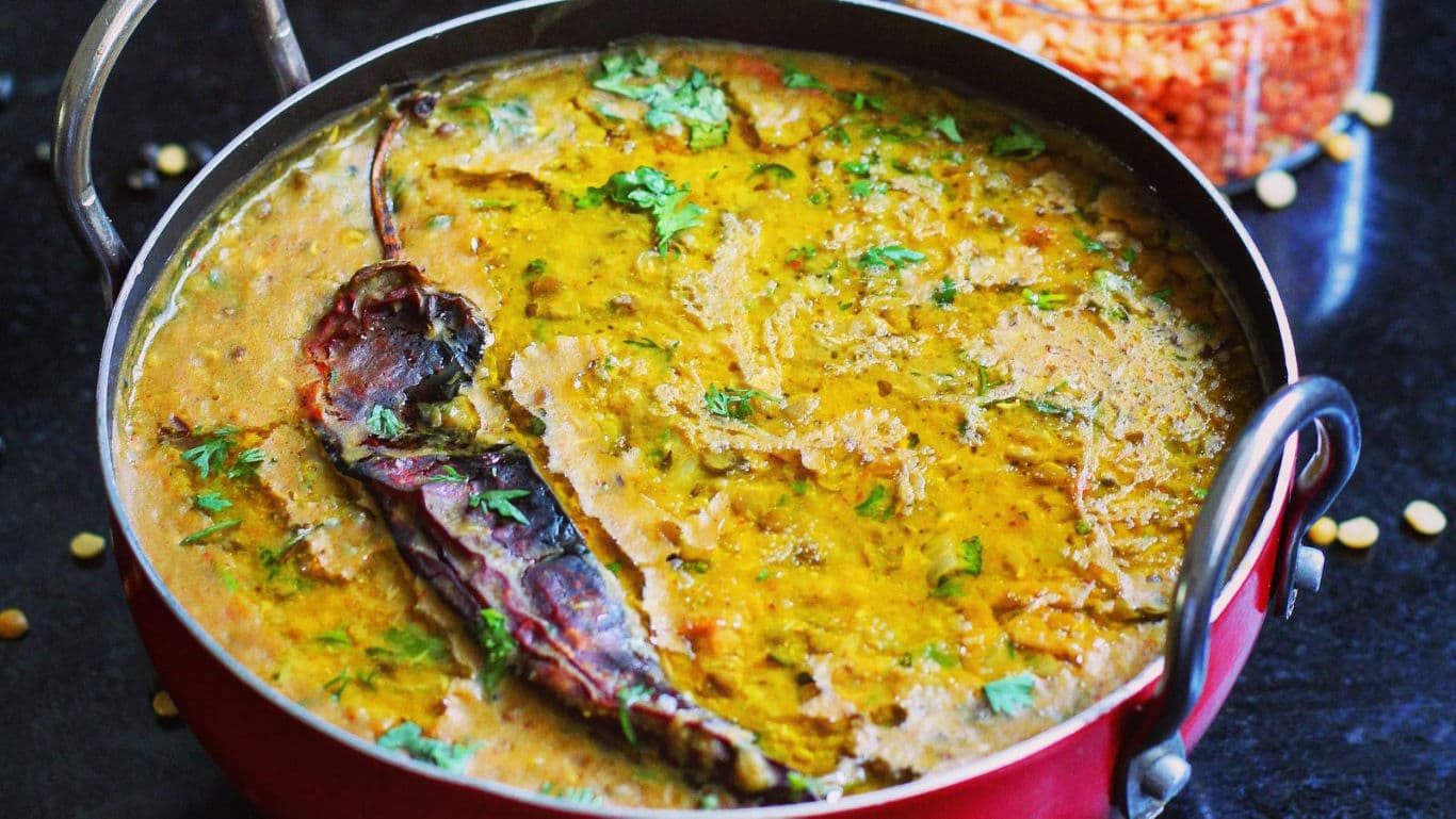 Spicy lentil curry in red pot