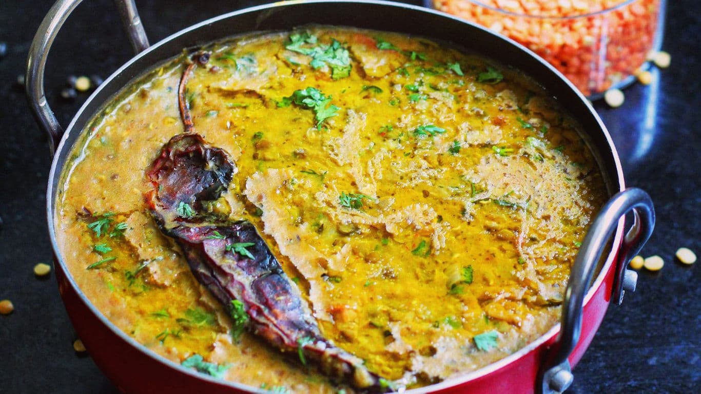 Indian lentil dal with spices and herbs in pot