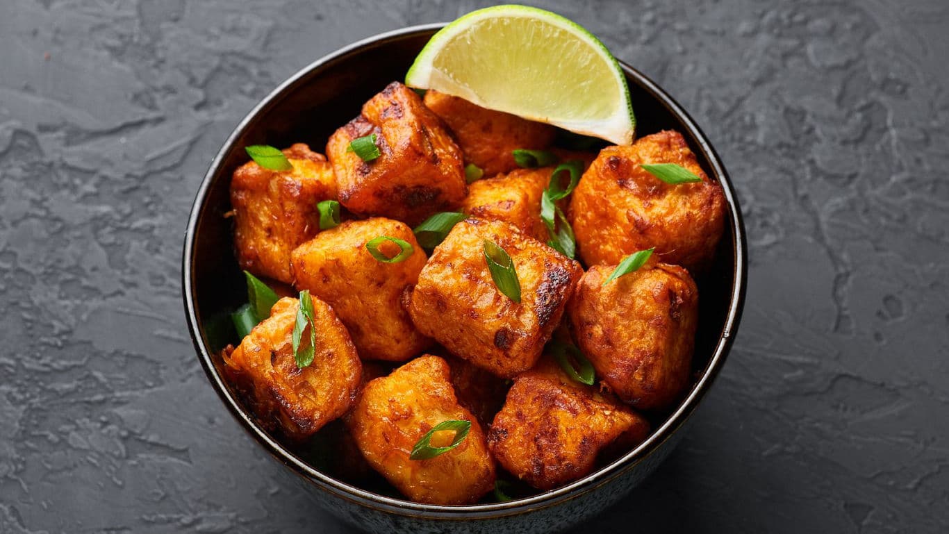 Crispy fried tofu with lime garnish