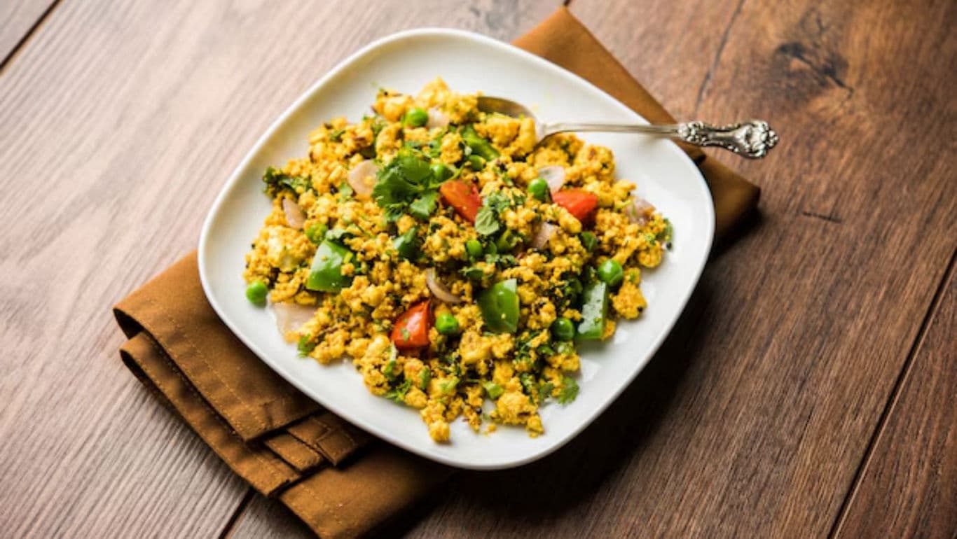 Colorful vegetable paneer scramble on white plate