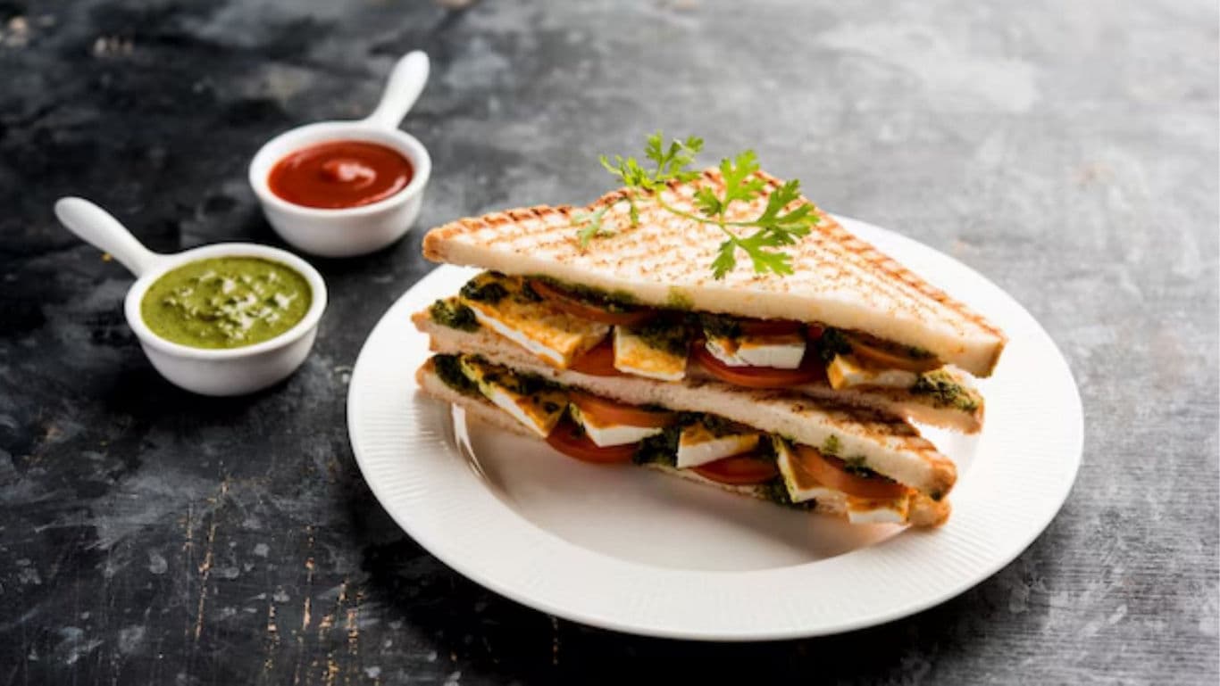 Grilled sandwich with sauces on plate