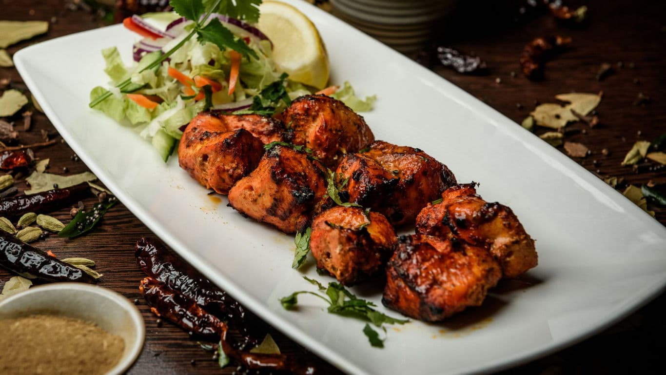 Grilled chicken skewers with fresh salad
