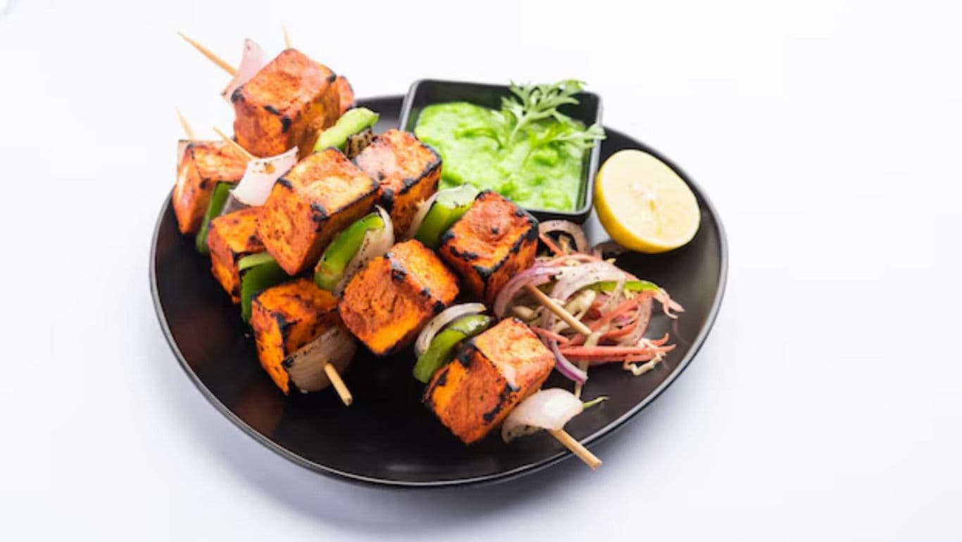 Grilled paneer tikka skewers with green chutney dip