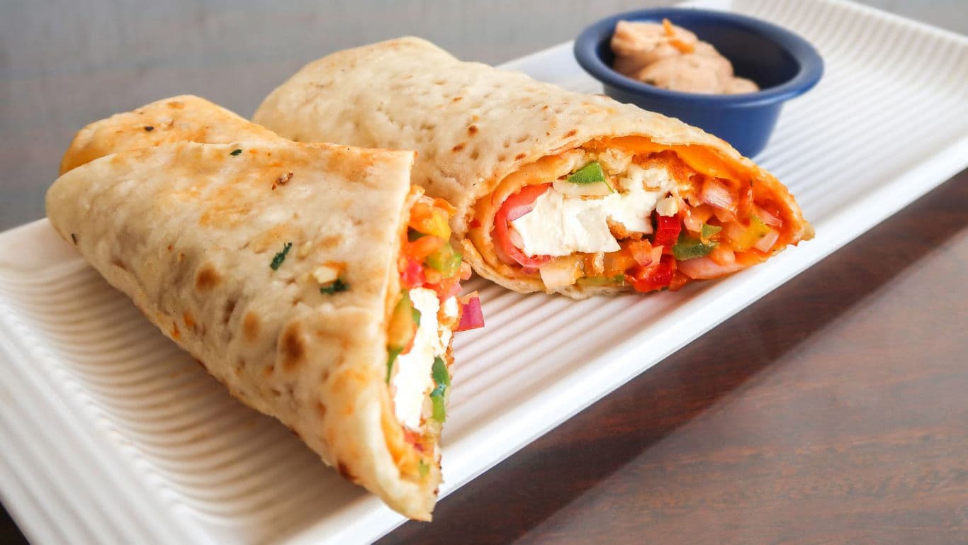 Vegetarian wraps with dip on plate