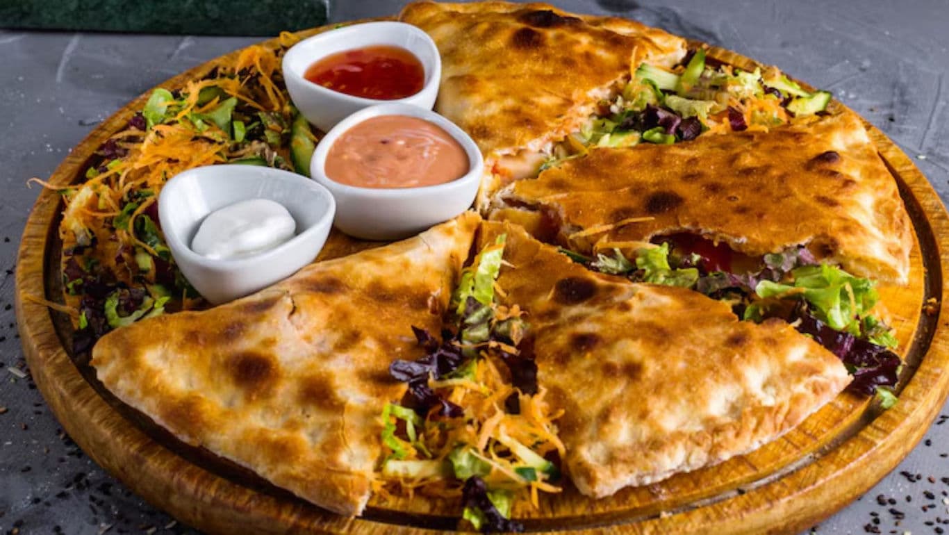 Vegetable stuffed quesadilla with assorted dipping sauces
