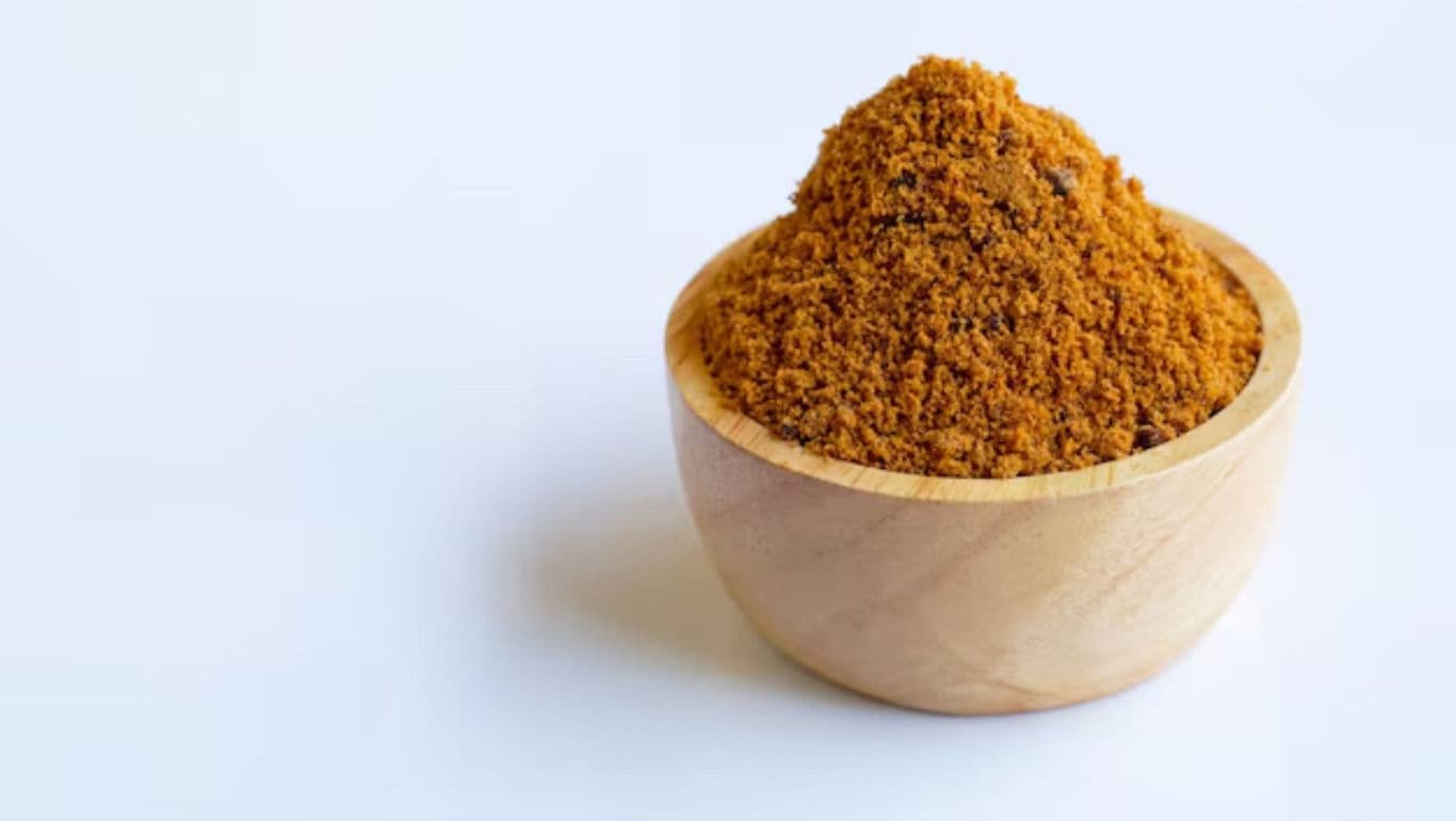 Wooden bowl filled with ground spice