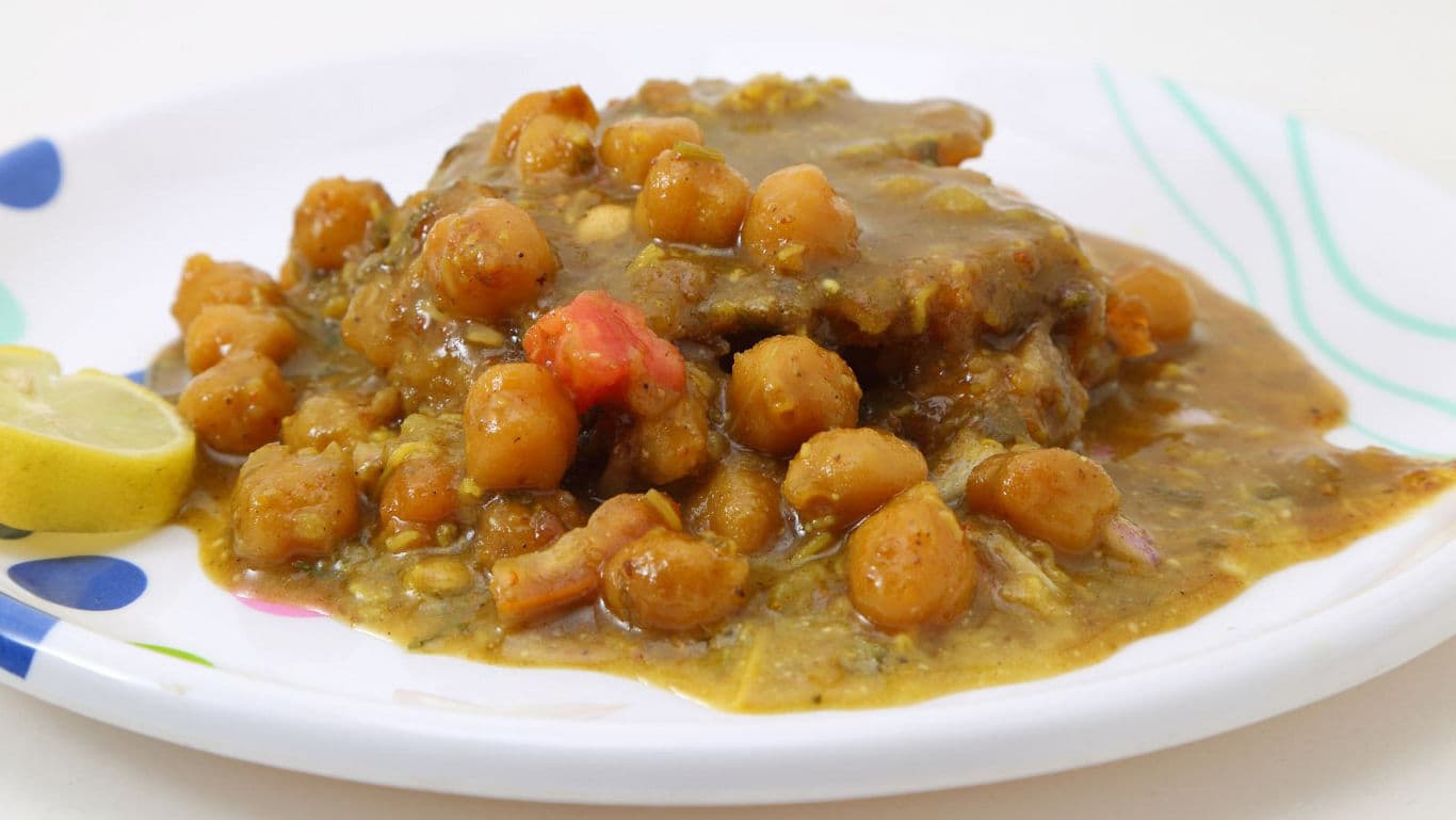 Chickpea curry served on a white plate