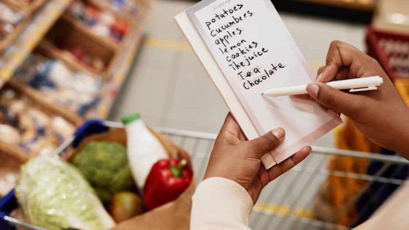 Handwriting grocery list in supermarket aisle