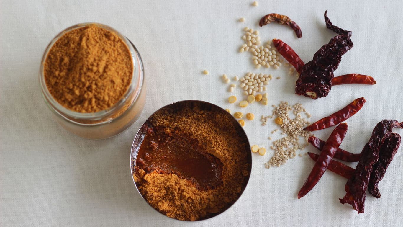 Spices and chili powder on white background