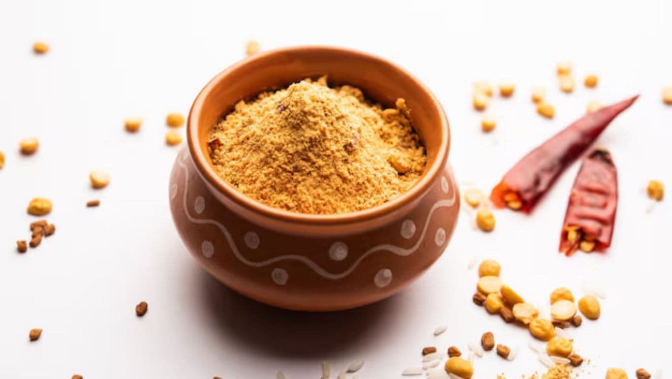 Spiced powder in clay bowl with ingredients
