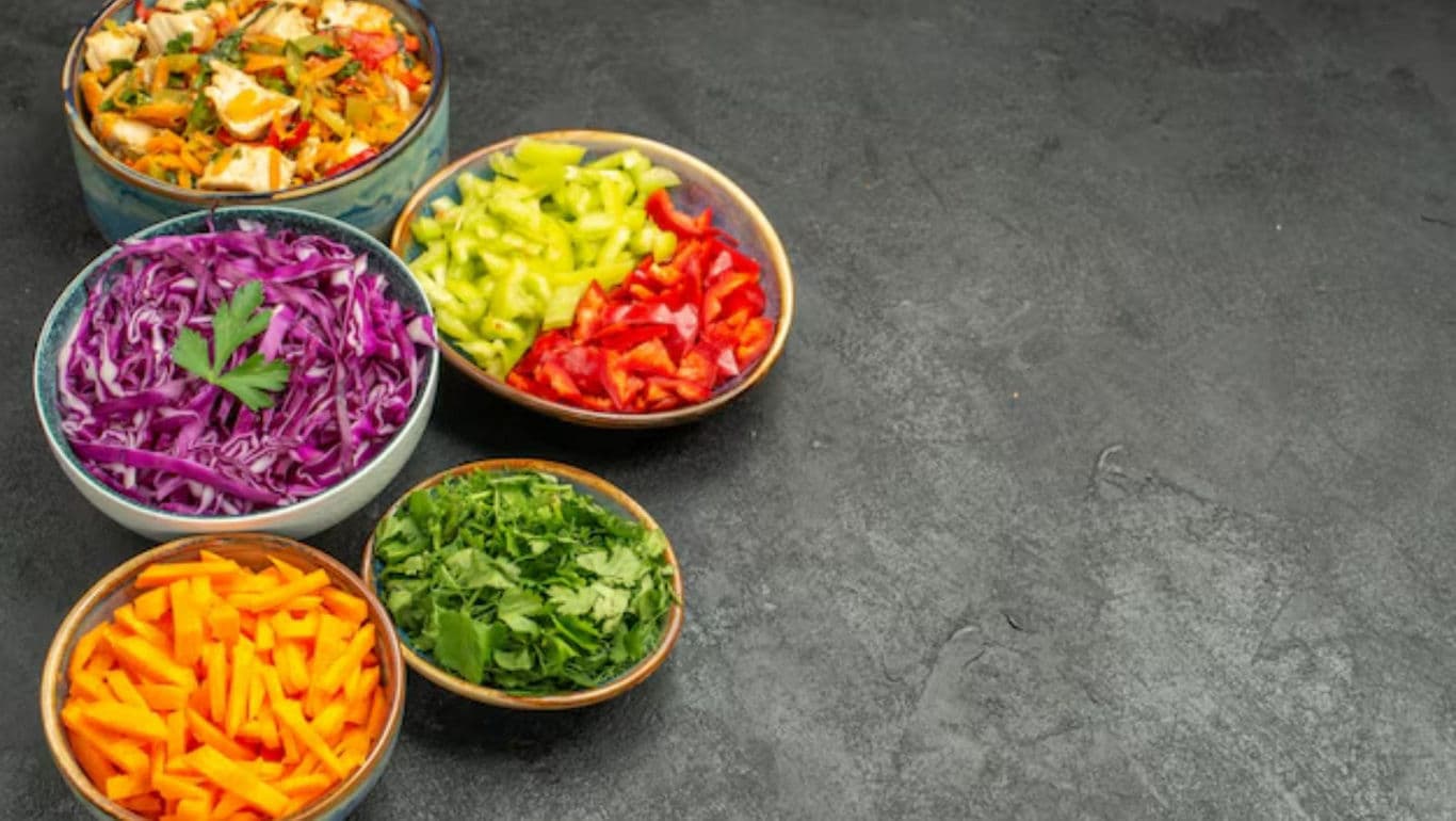 Colorful bowls of fresh chopped vegetables