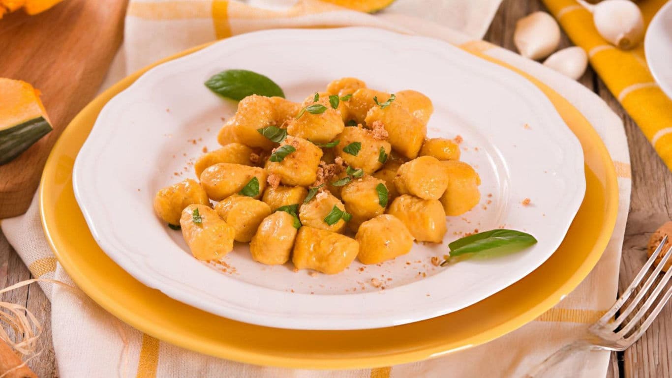 Pumpkin gnocchi on white plate