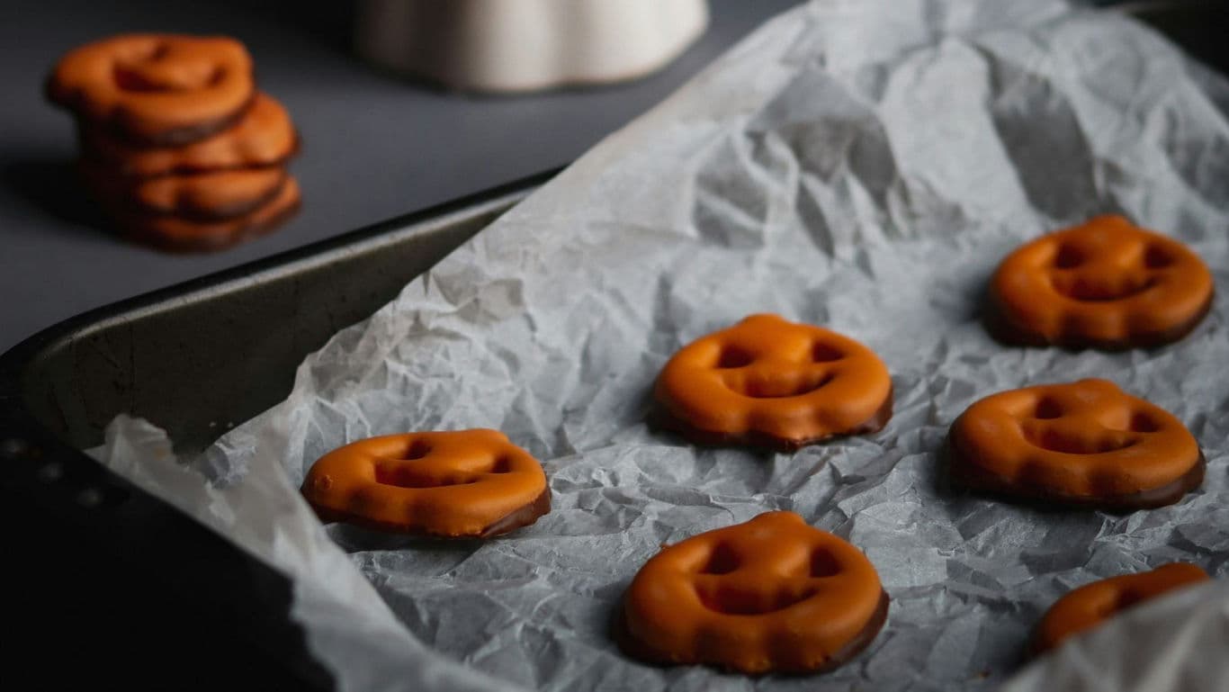 Pumpkin-shaped cookies on baking tray