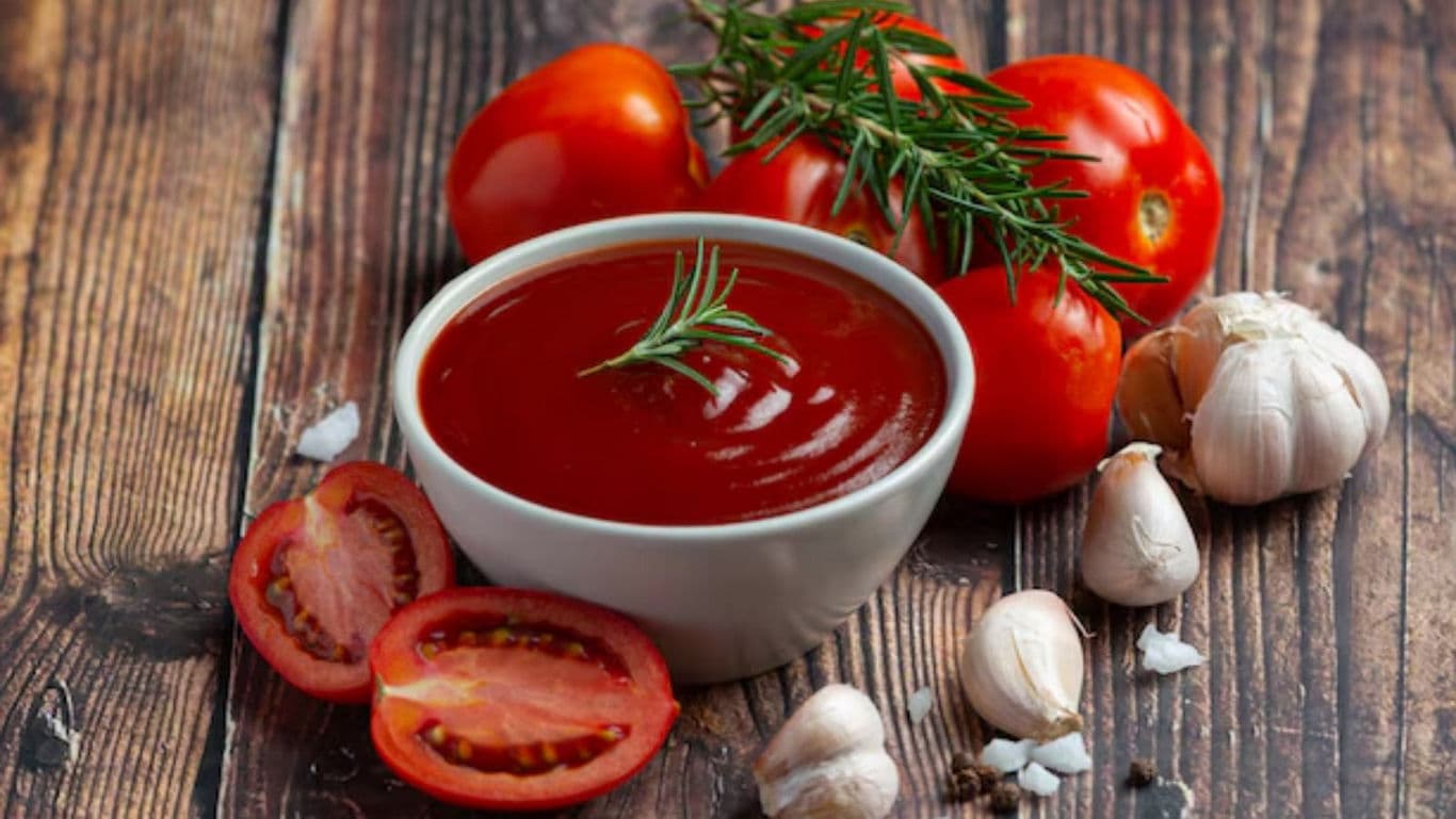 Fresh tomato sauce in bowl with herbs and garlic