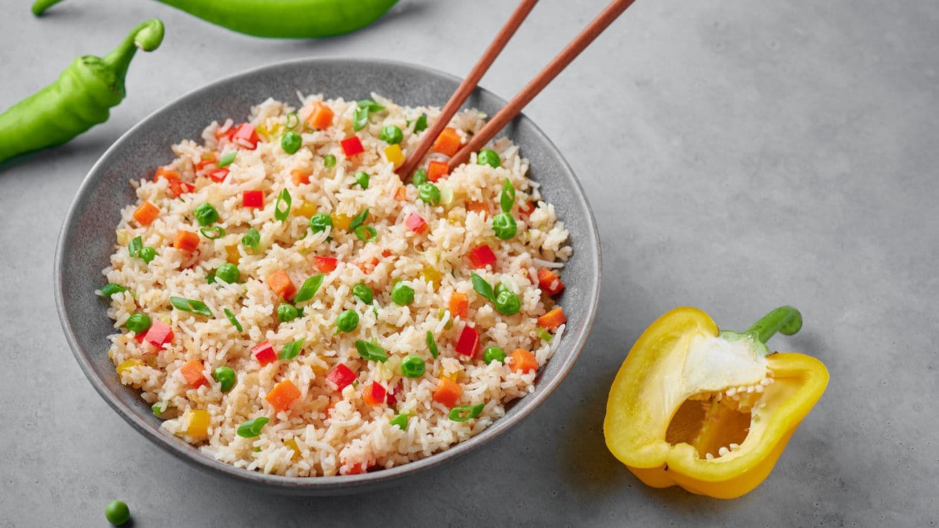 Colorful vegetable fried rice with chopsticks