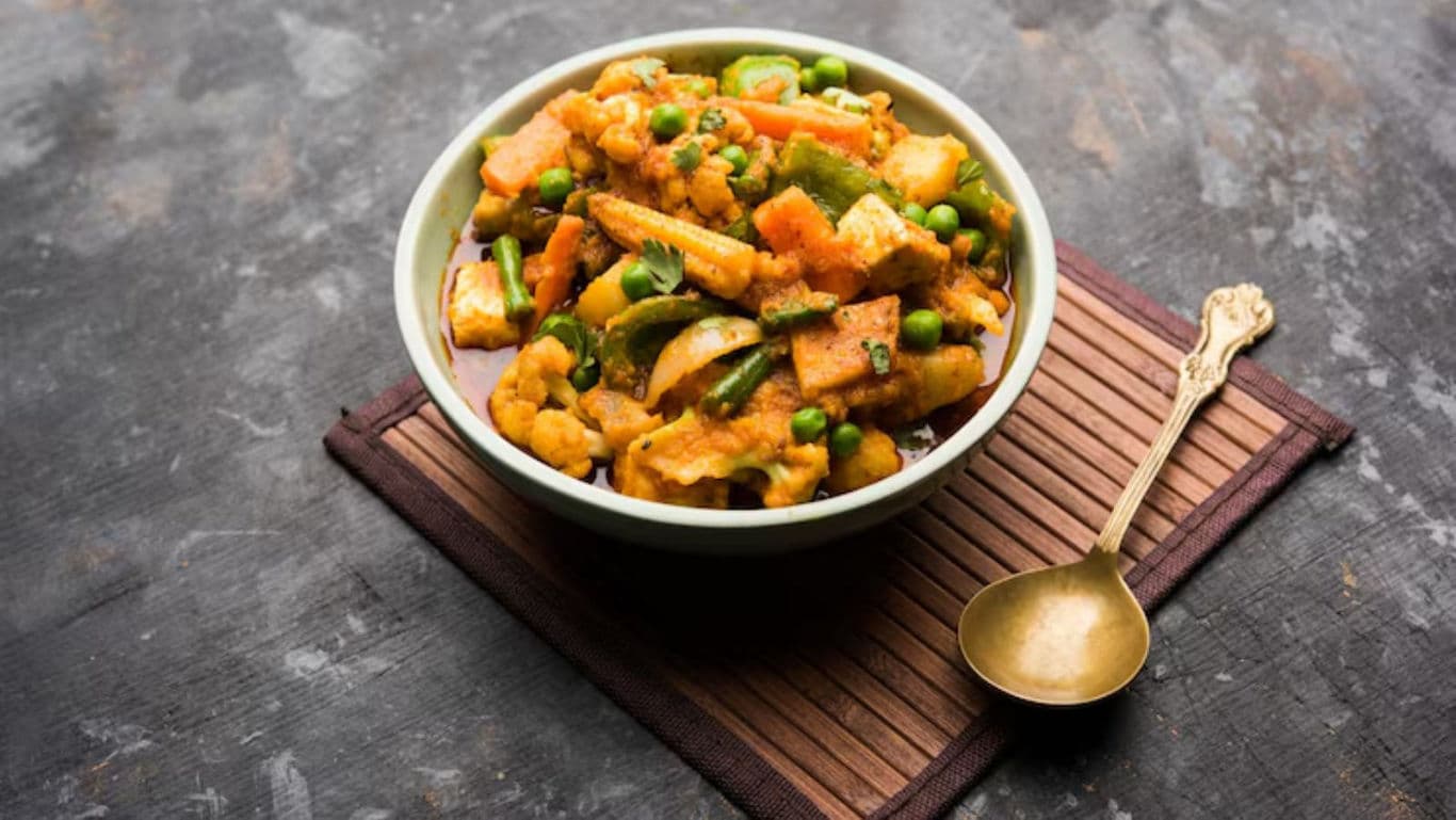 Mixed Vegetable Curry in White Bowl with Brass Spoon