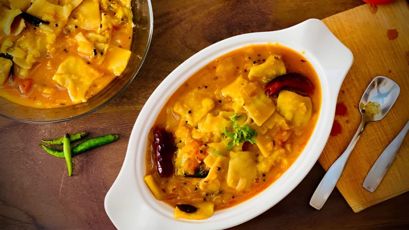 Spicy curry with dumplings in white bowl