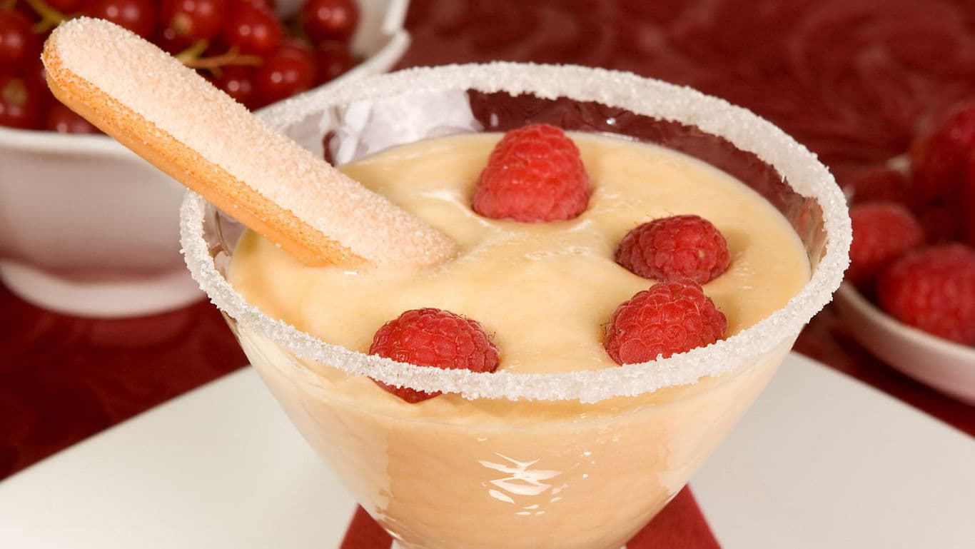 Yellow cheesecake topped with mango buttercream, a festive Bengali dessert.