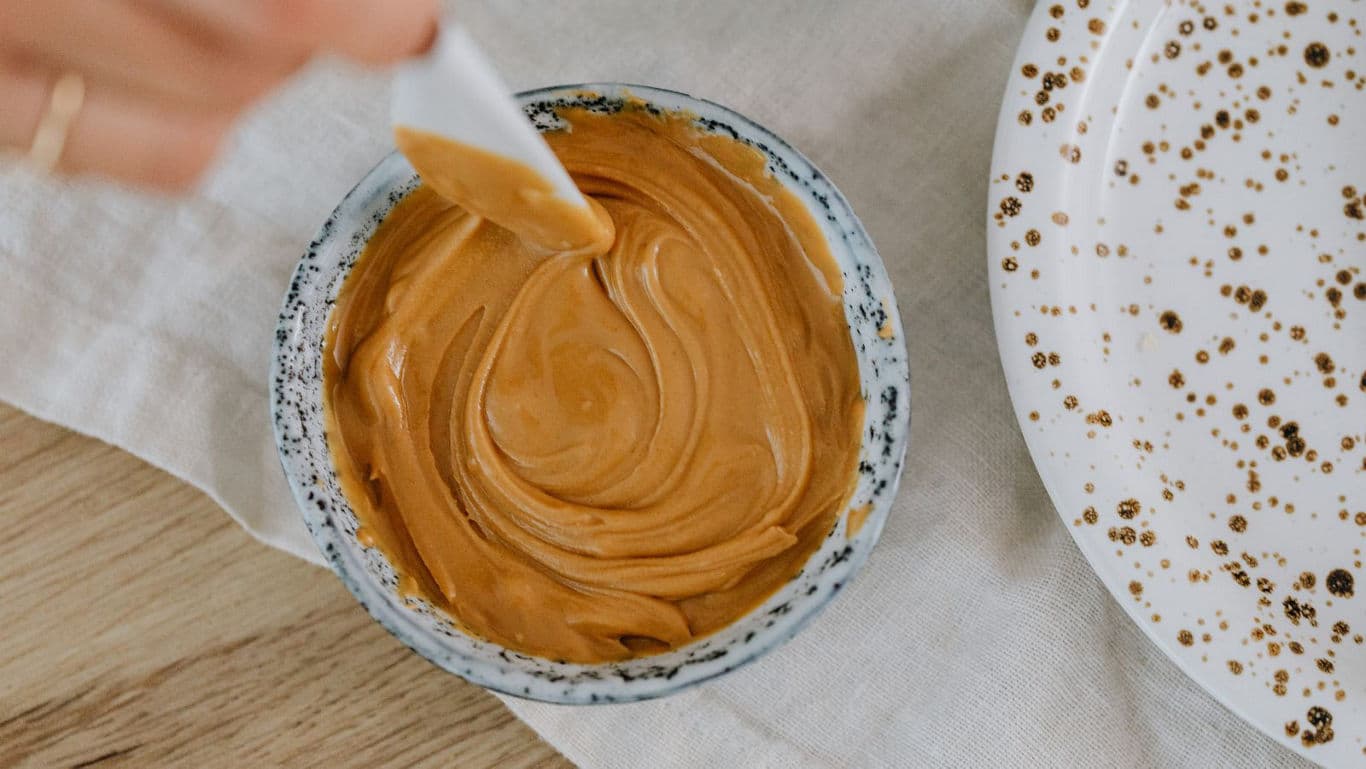 Creamy peanut butter in ceramic bowl
