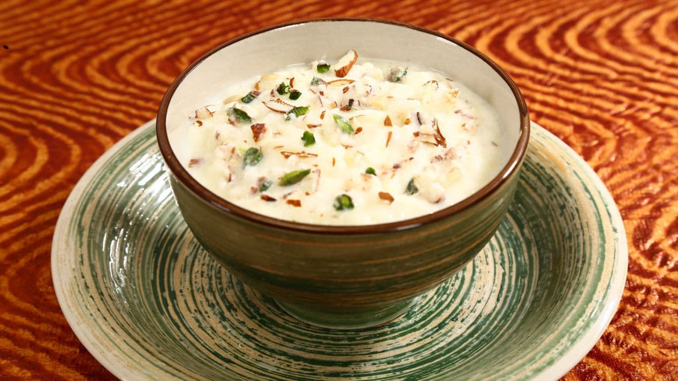 Creamy dessert bowl with nuts and garnish