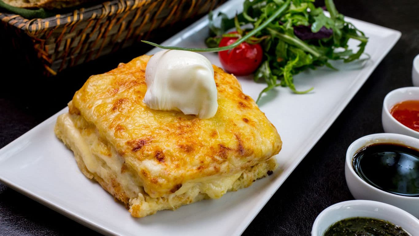 Cheesy baked dish with fresh salad