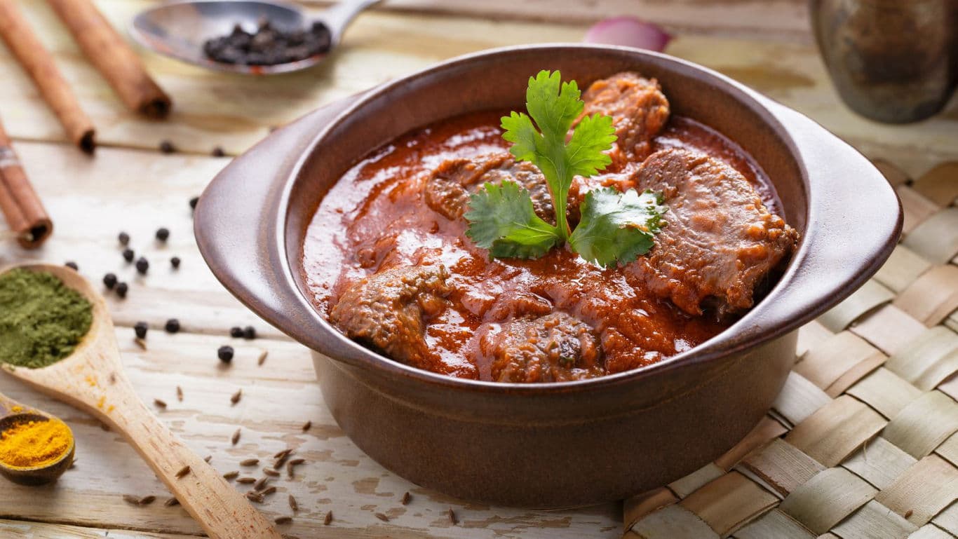 Spicy curry dish in brown ceramic bowl