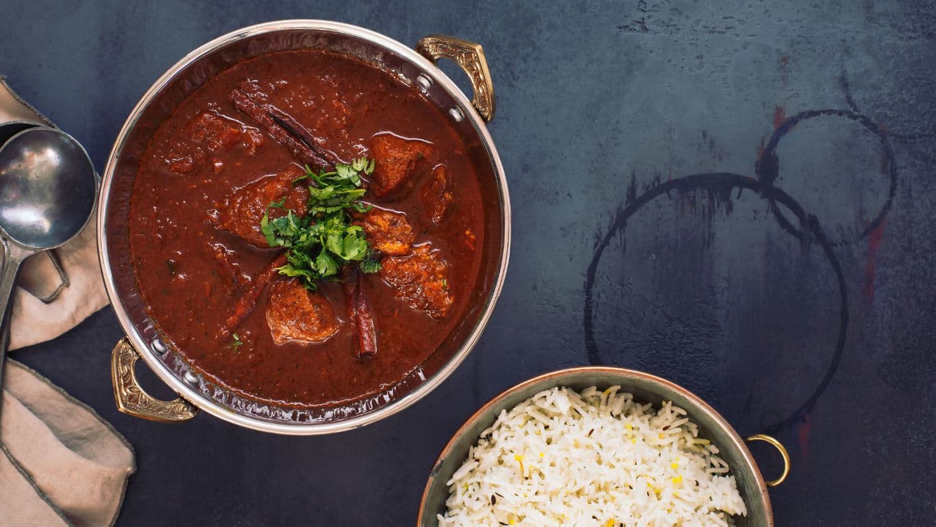 Rich curry with rice in elegant setting