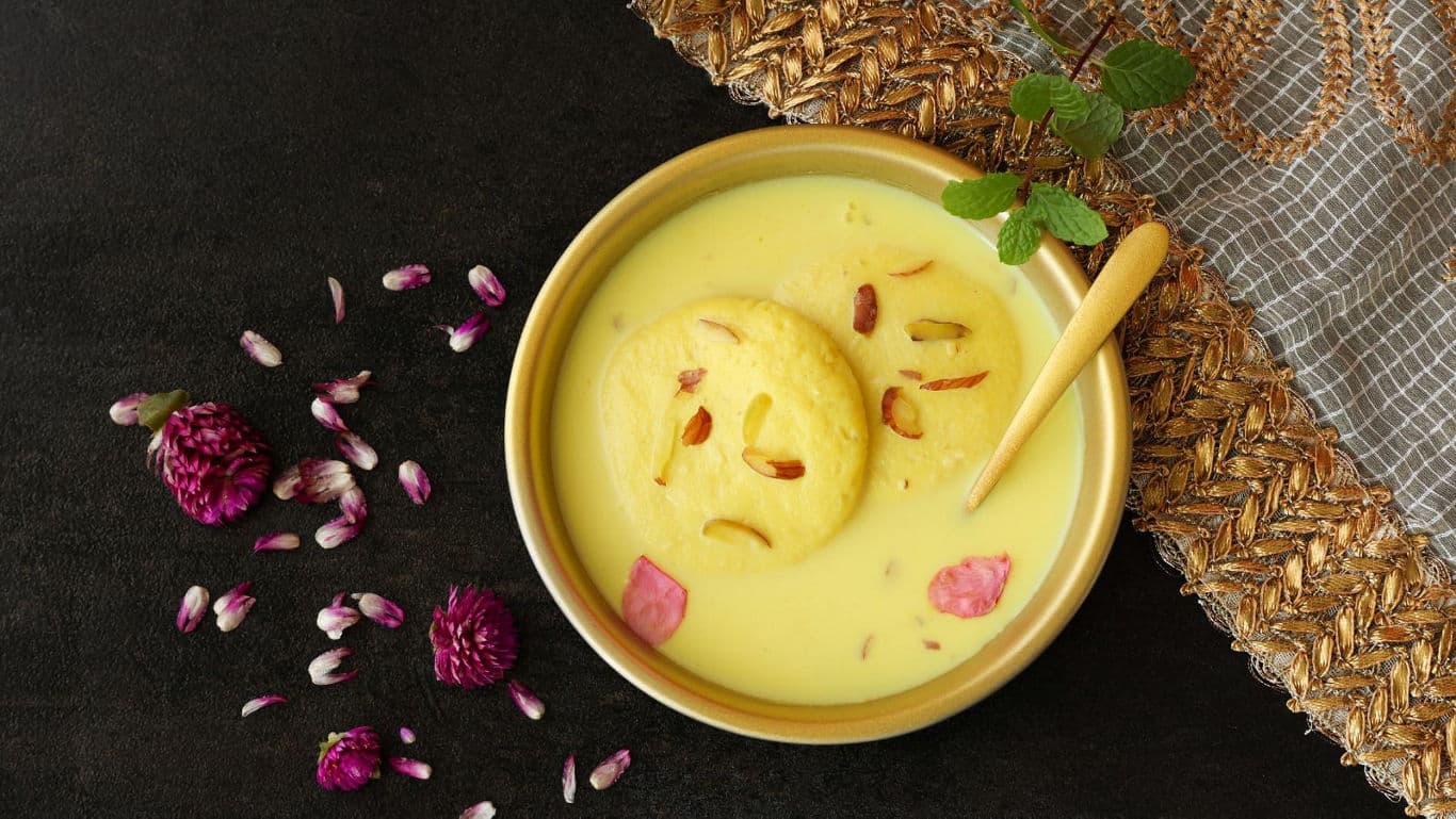Yellow cheesecake topped with mango buttercream, a festive Bengali dessert.