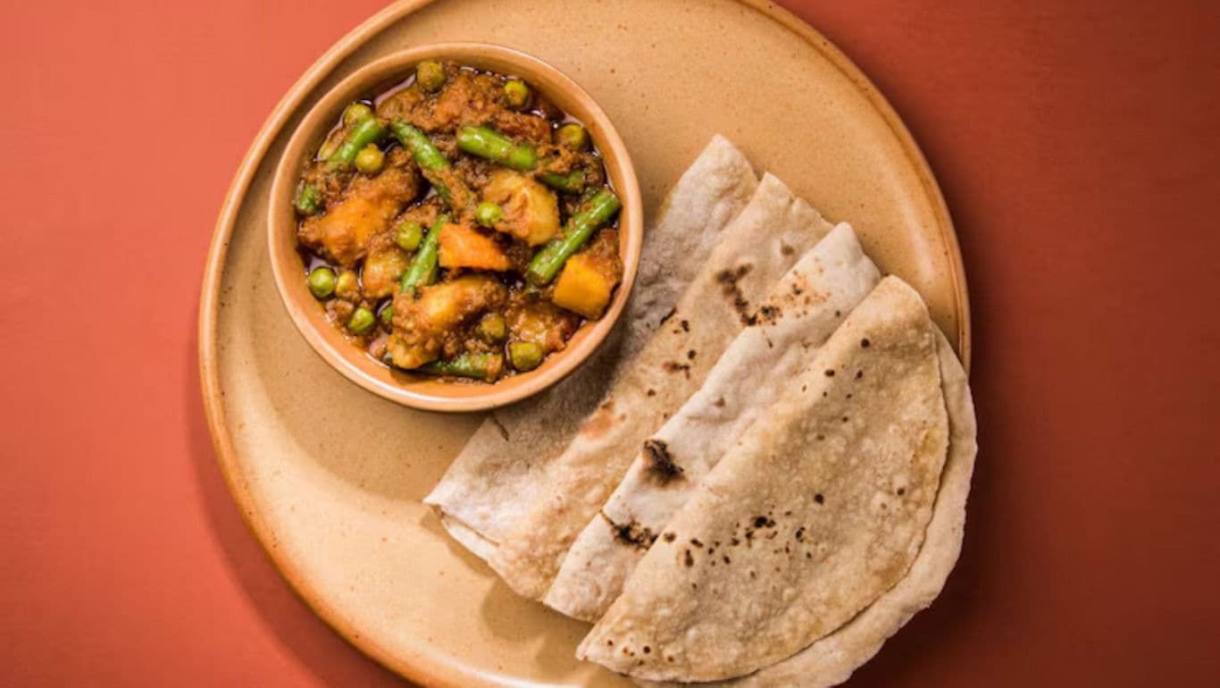 Indian curry with flatbread on plate
