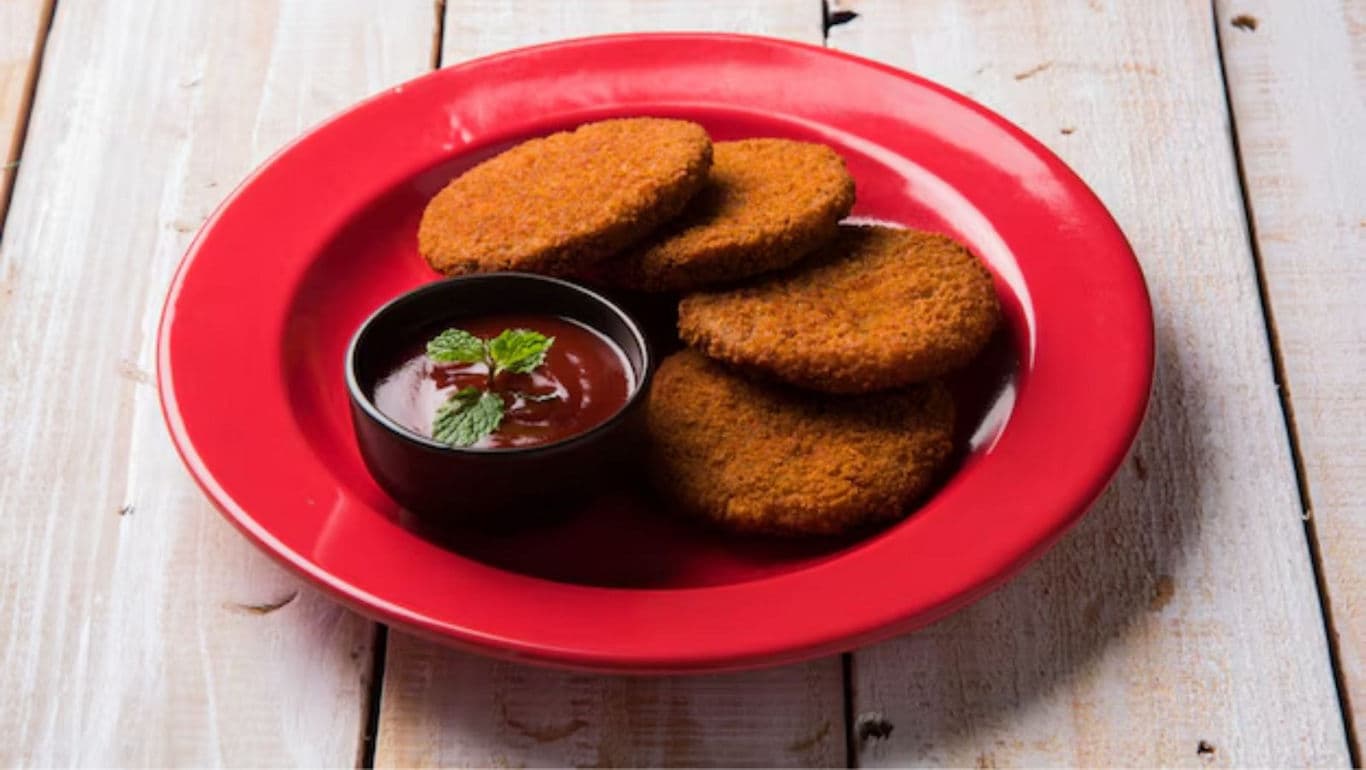 Crispy cutlets with dipping sauce on red plate