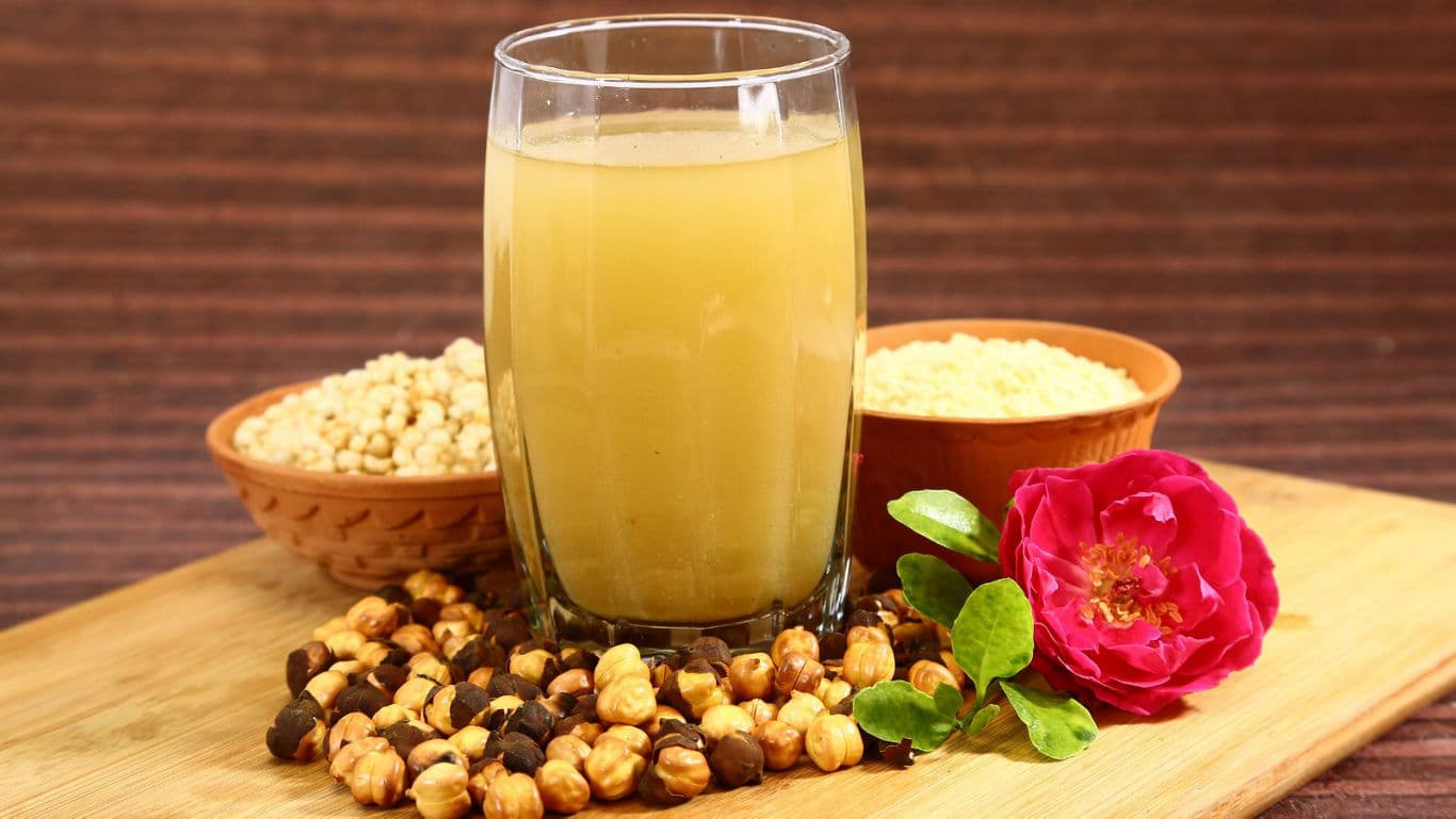 Glass of nut-based drink with rose garnish