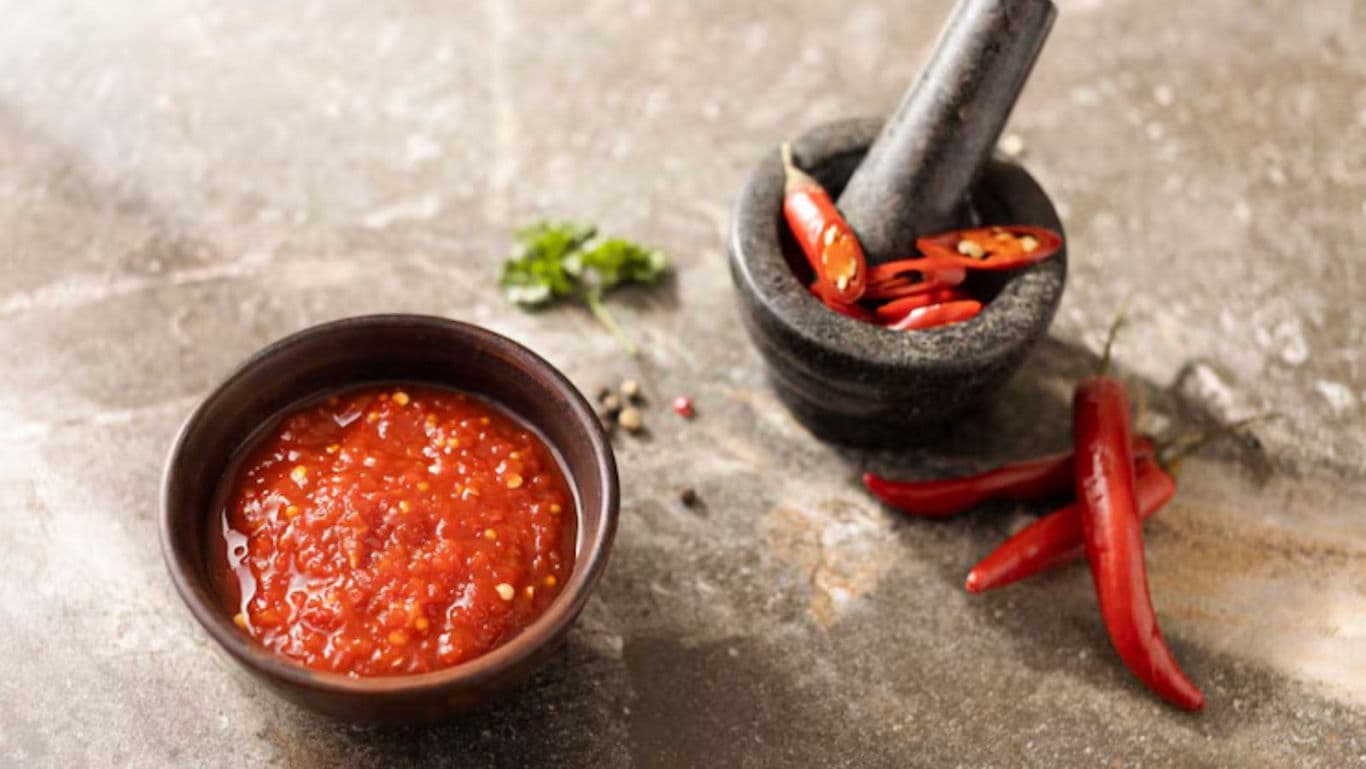 Fresh chili sauce with mortar and pestle