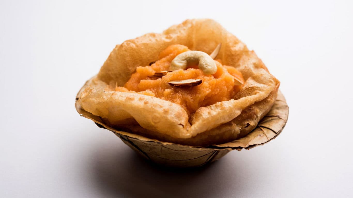 halwa, poori, chana dishes arranged for puja.