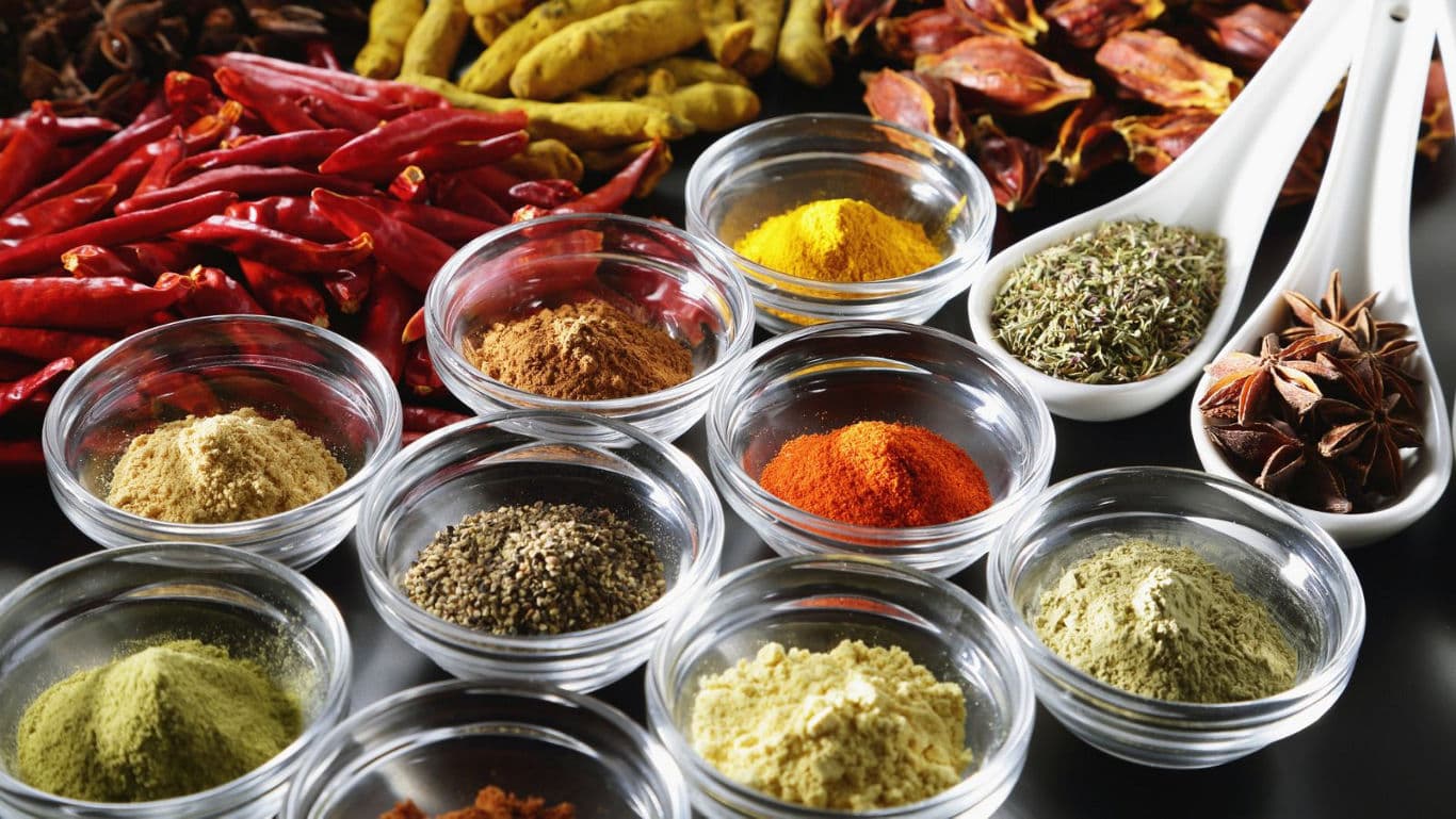 Assorted Colorful Spices in Glass Bowls and Spoons