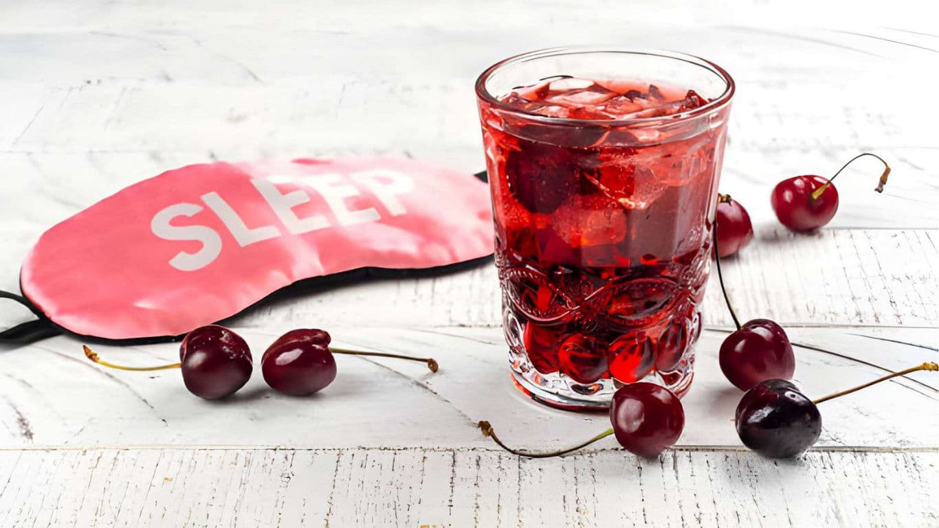 Cherry drink with sleep mask on table