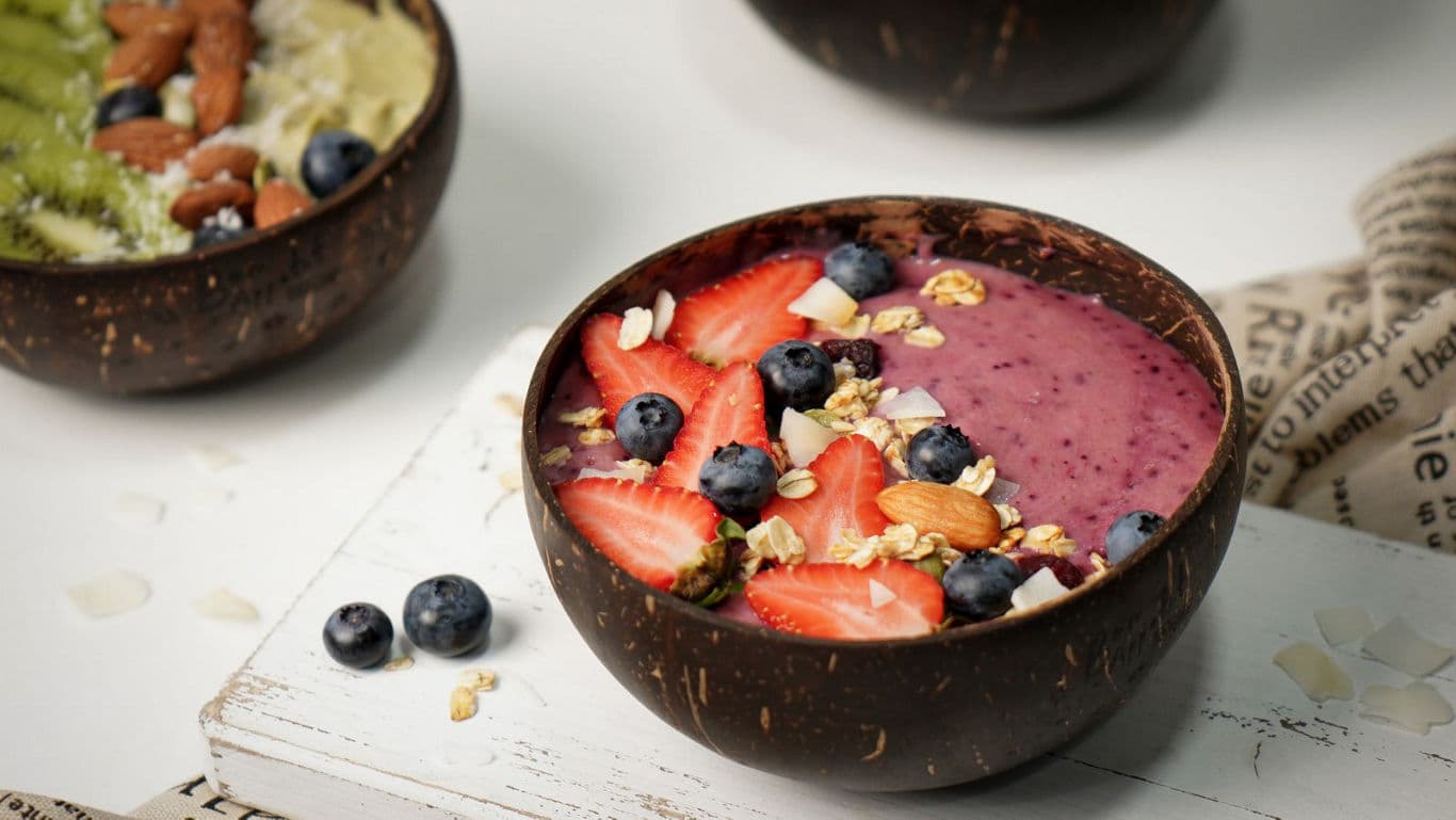 Berry smoothie bowl with fresh fruit and nuts