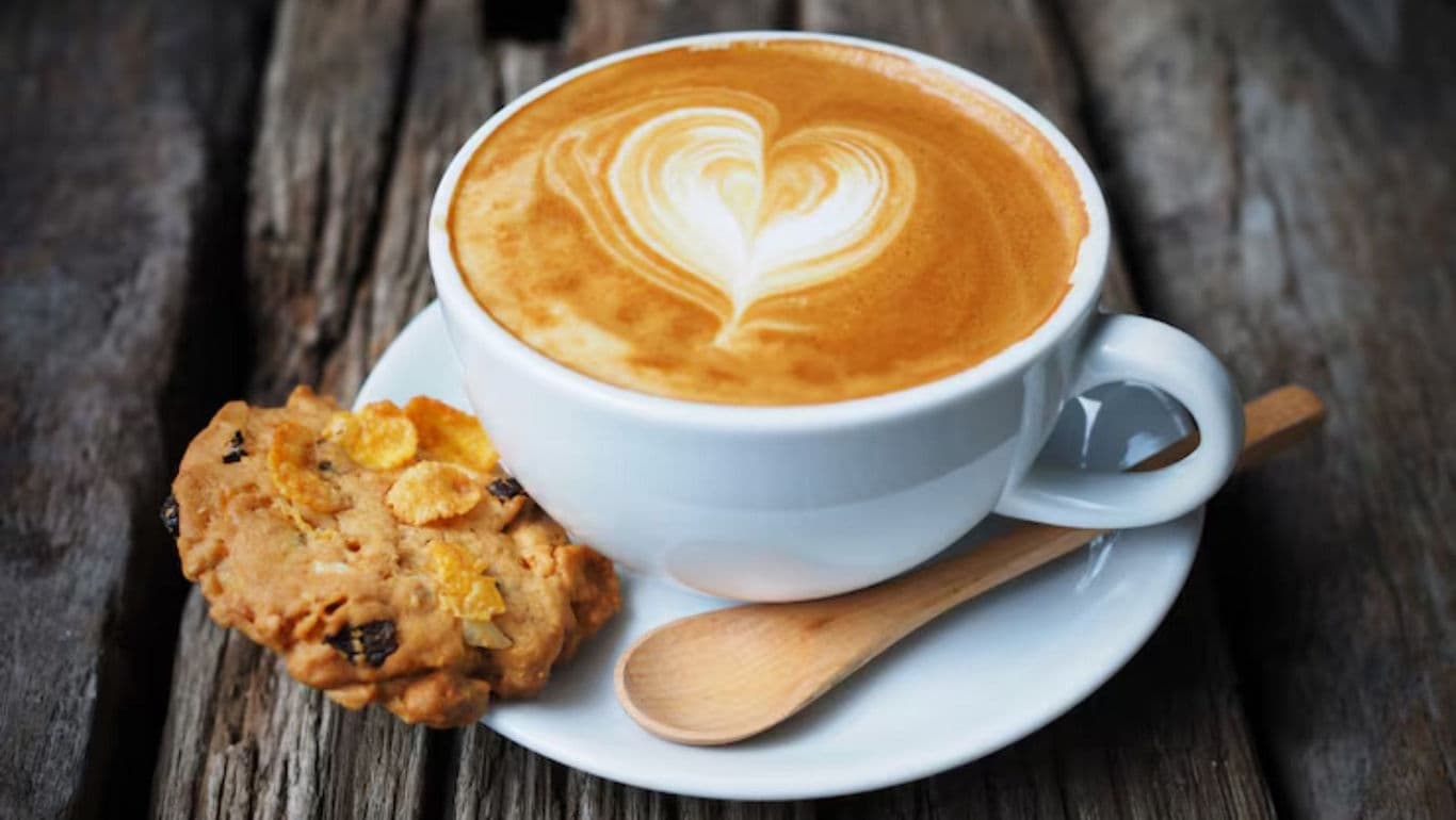 Latte Art Coffee with Cookie on Rustic Table