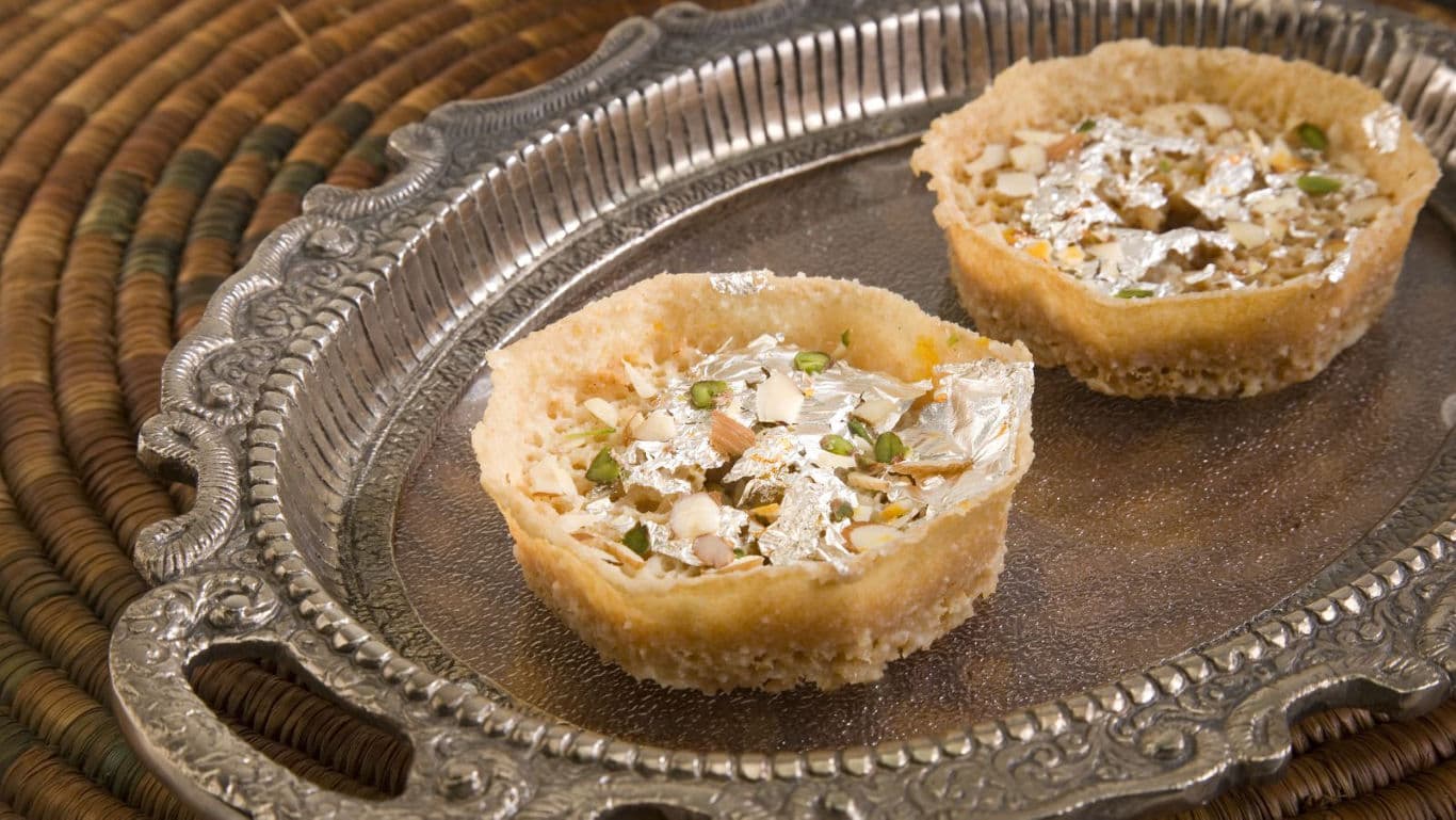 Traditional Indian sweets with silver leaf on tray