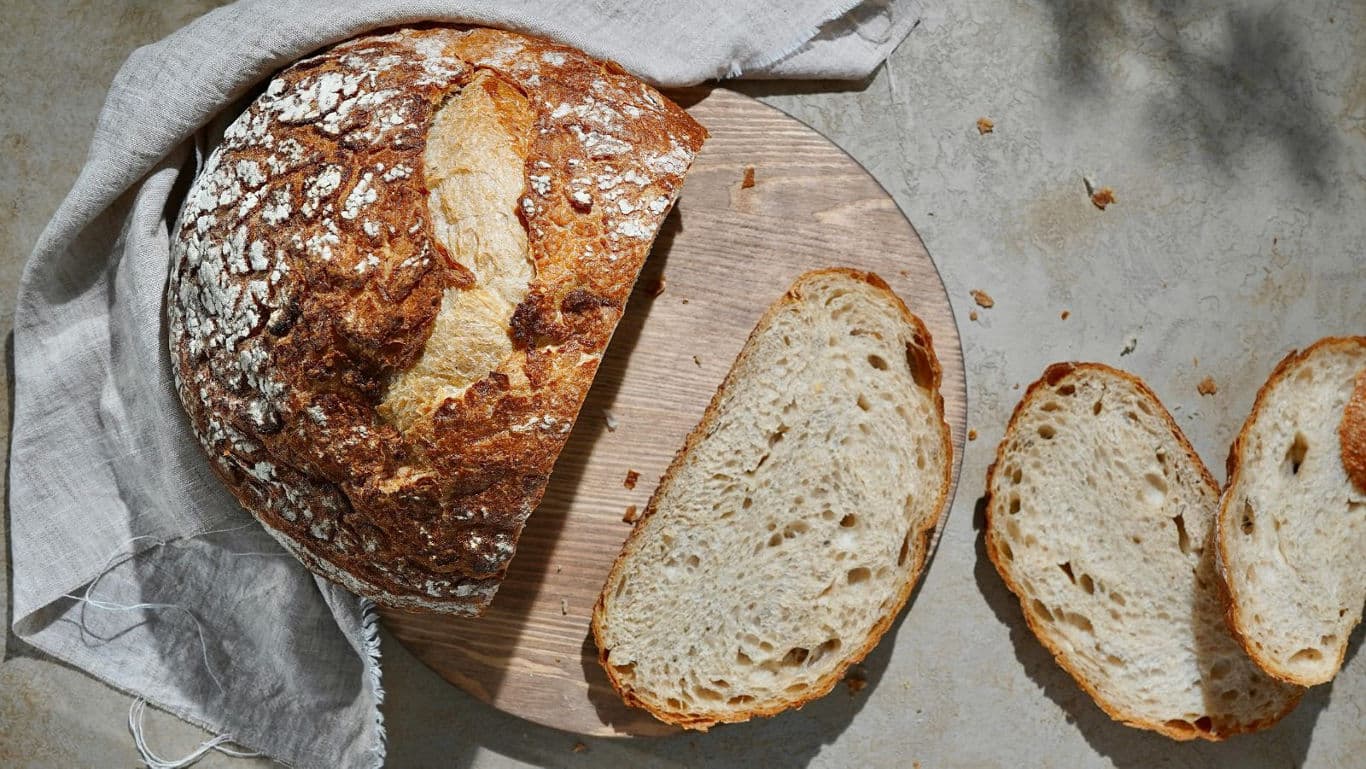 Rustic bread loaf with sliced pieces
