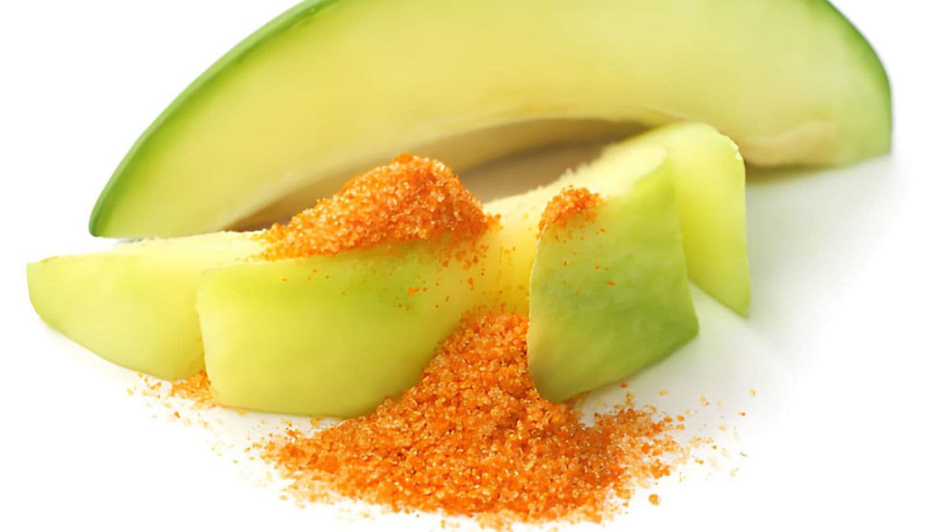 Fresh green mango slices with chili powder